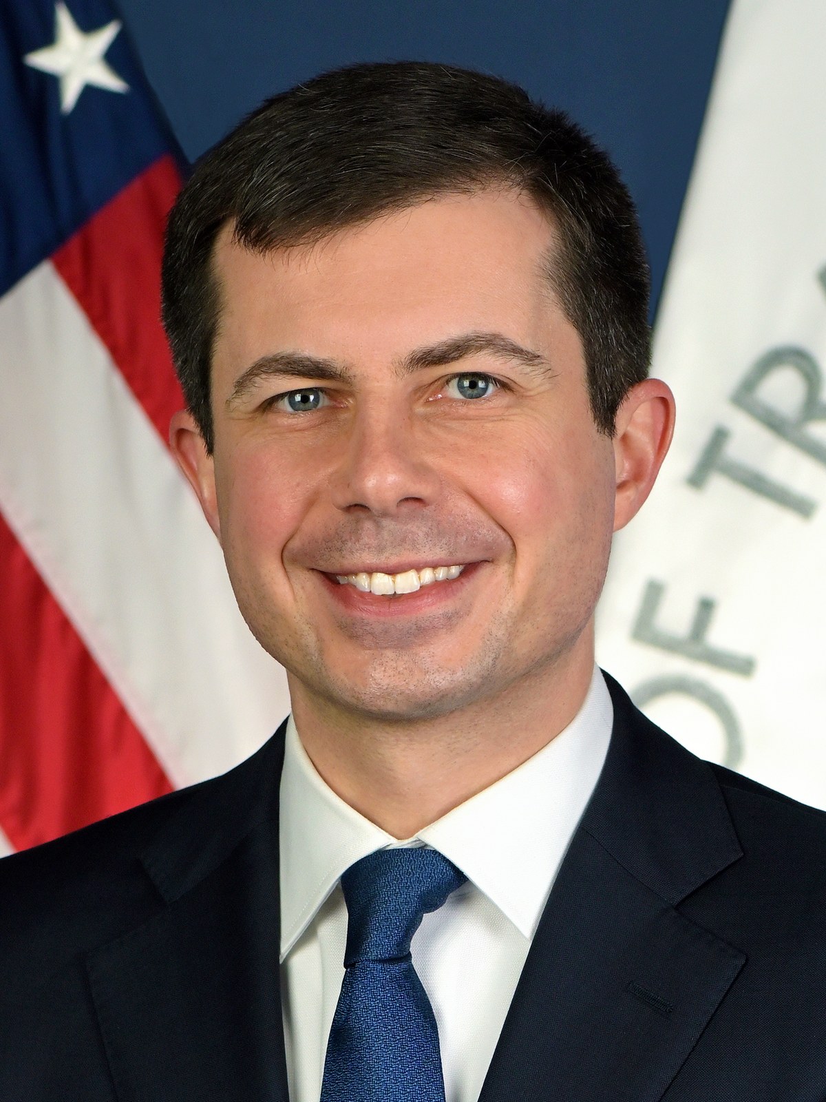 Official portrait of Pete Buttigieg in front of the United States flag